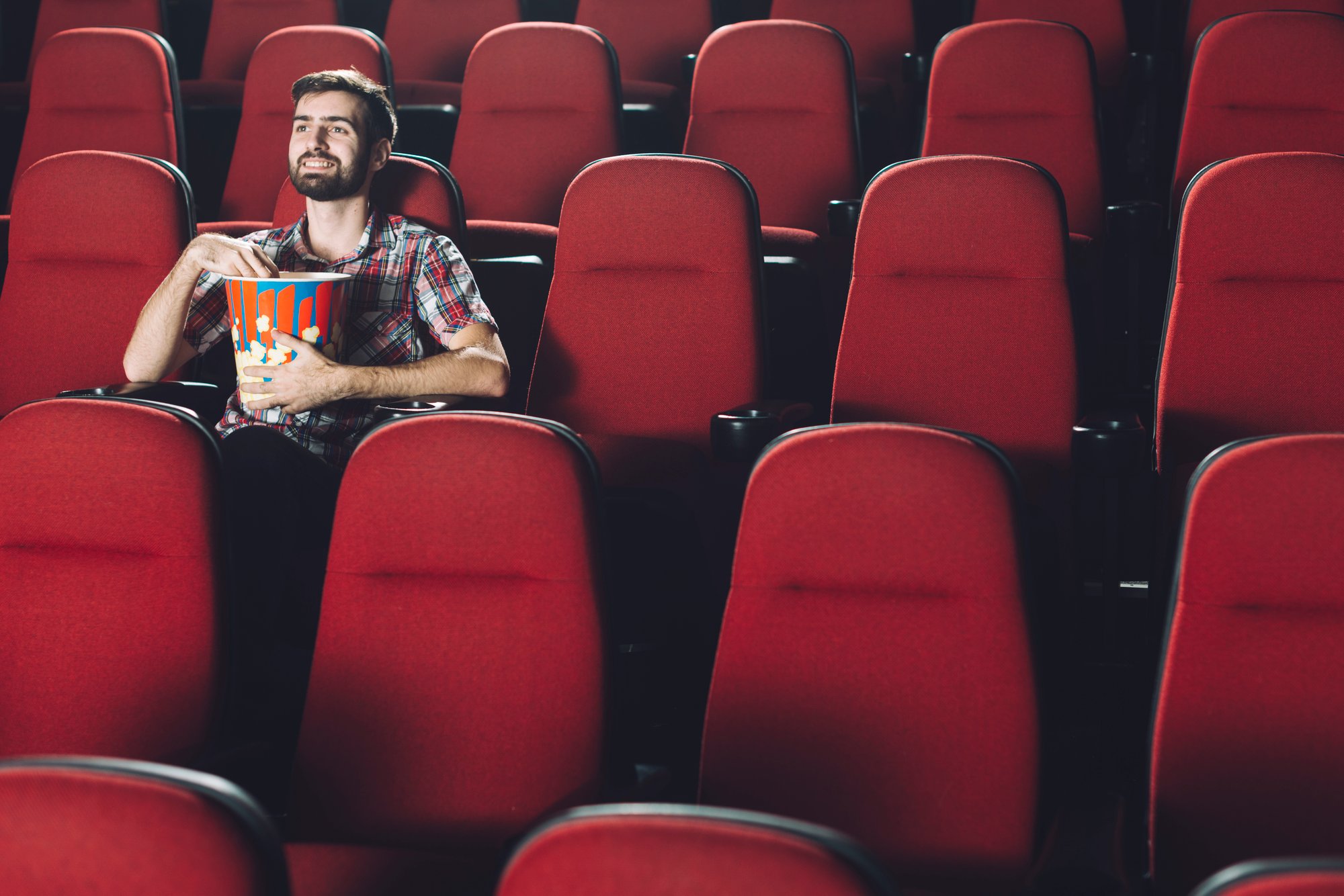 smiling-man-eating-popcorn-cinema
